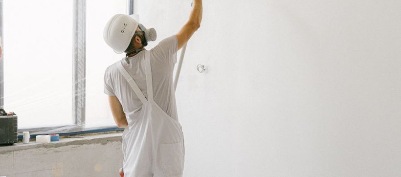 Painter working on an interior wall