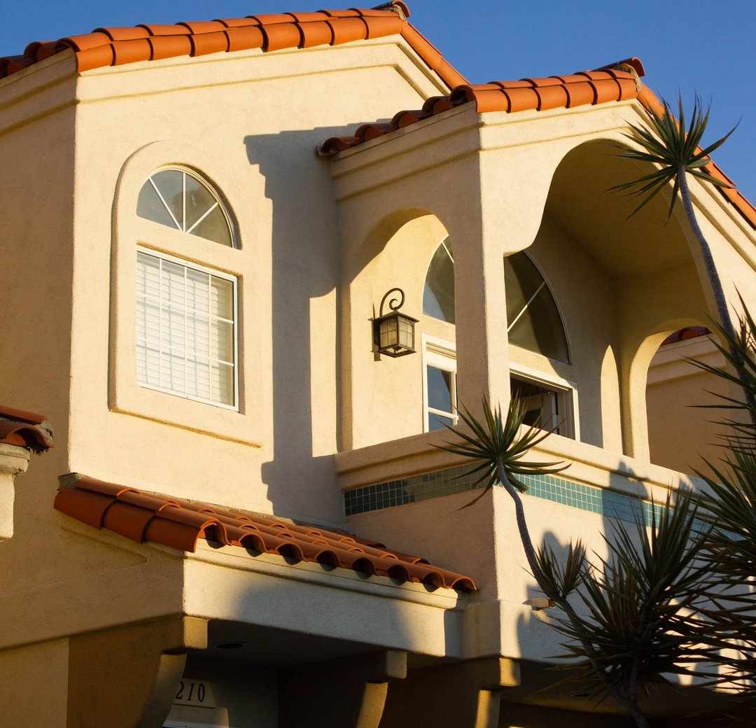 Warm stucco home with a freshly painted exterior