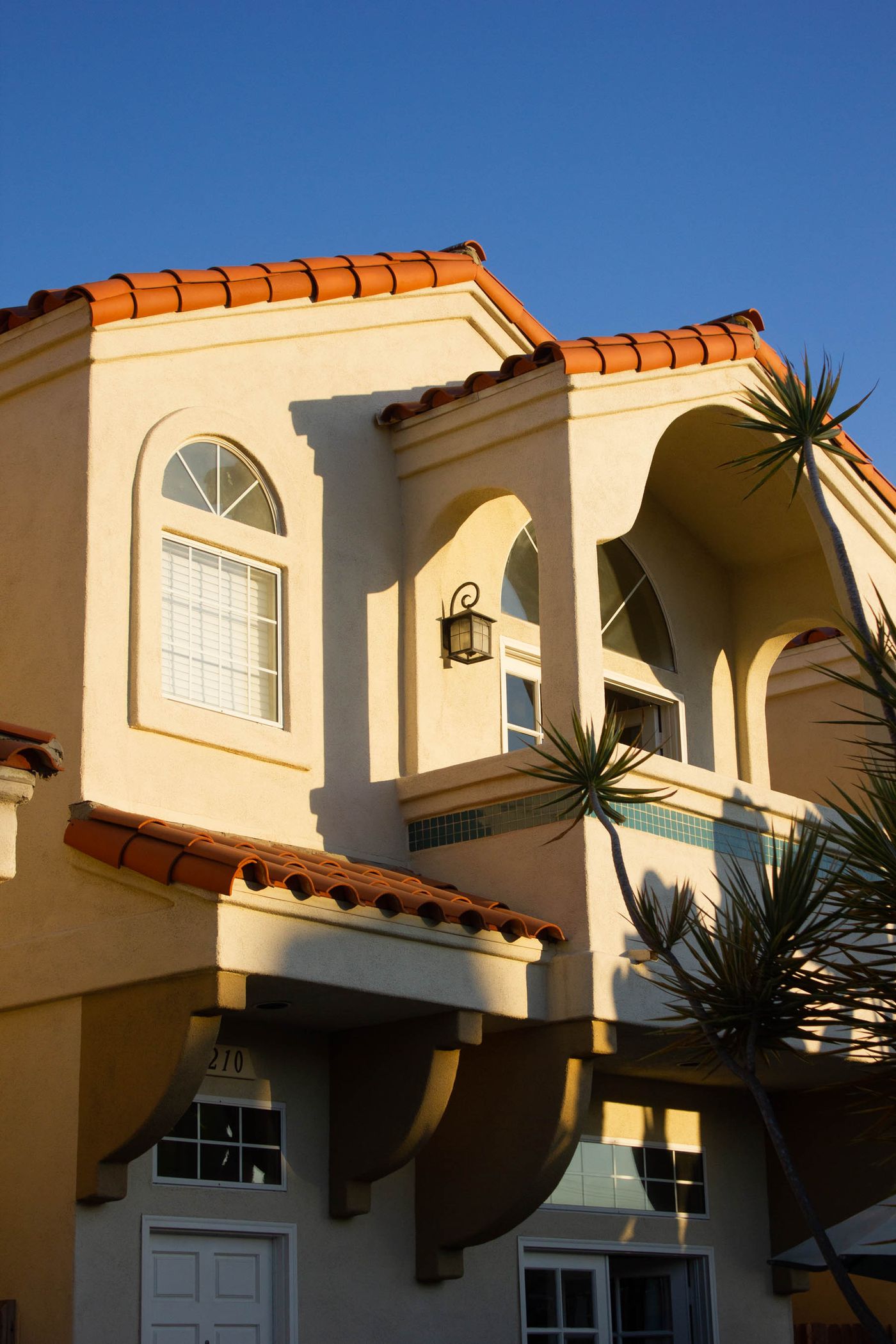 Sunlit stucco home with freshly painted exterior trim