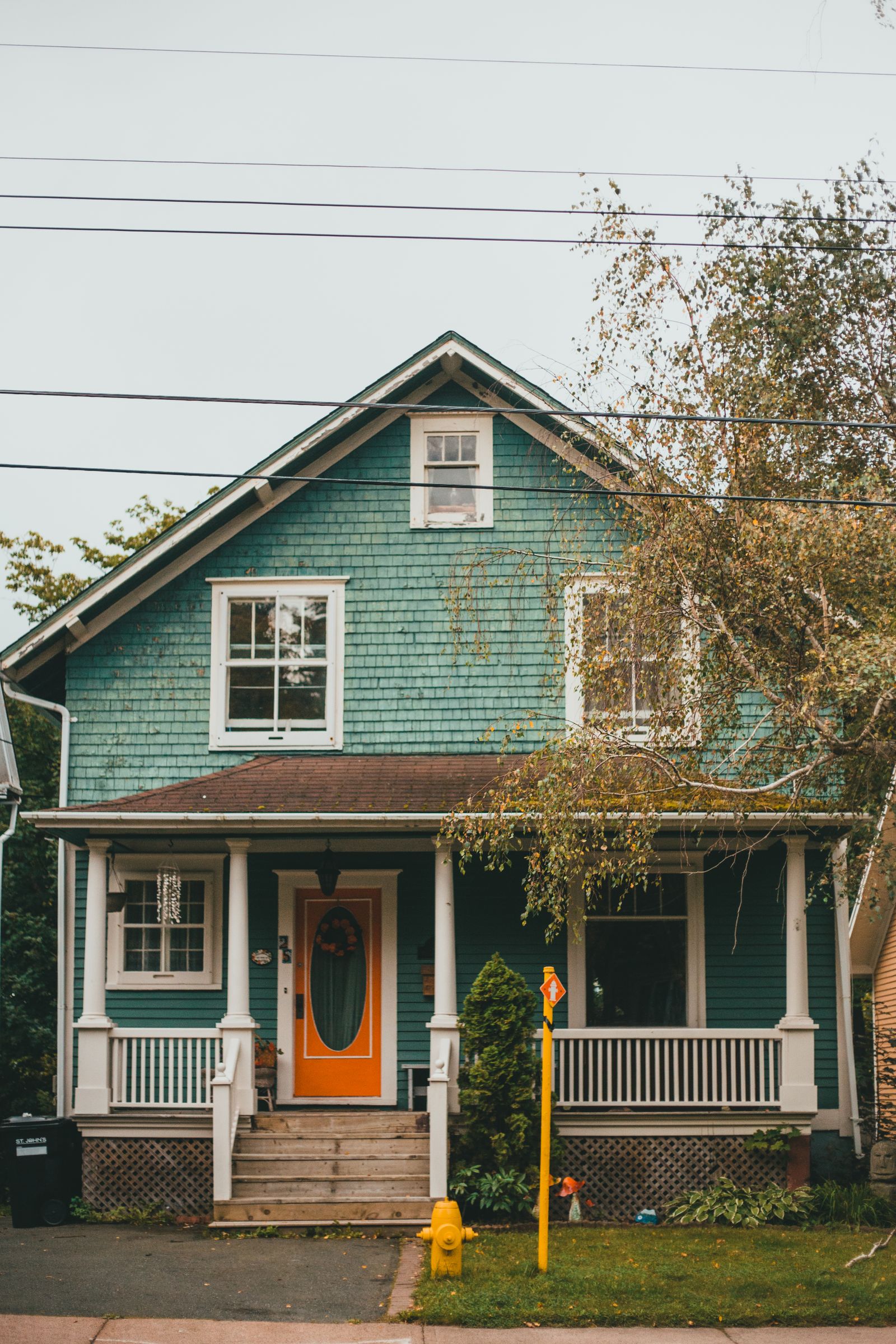 Green home with a freshly painted exterior body and contrasting trim