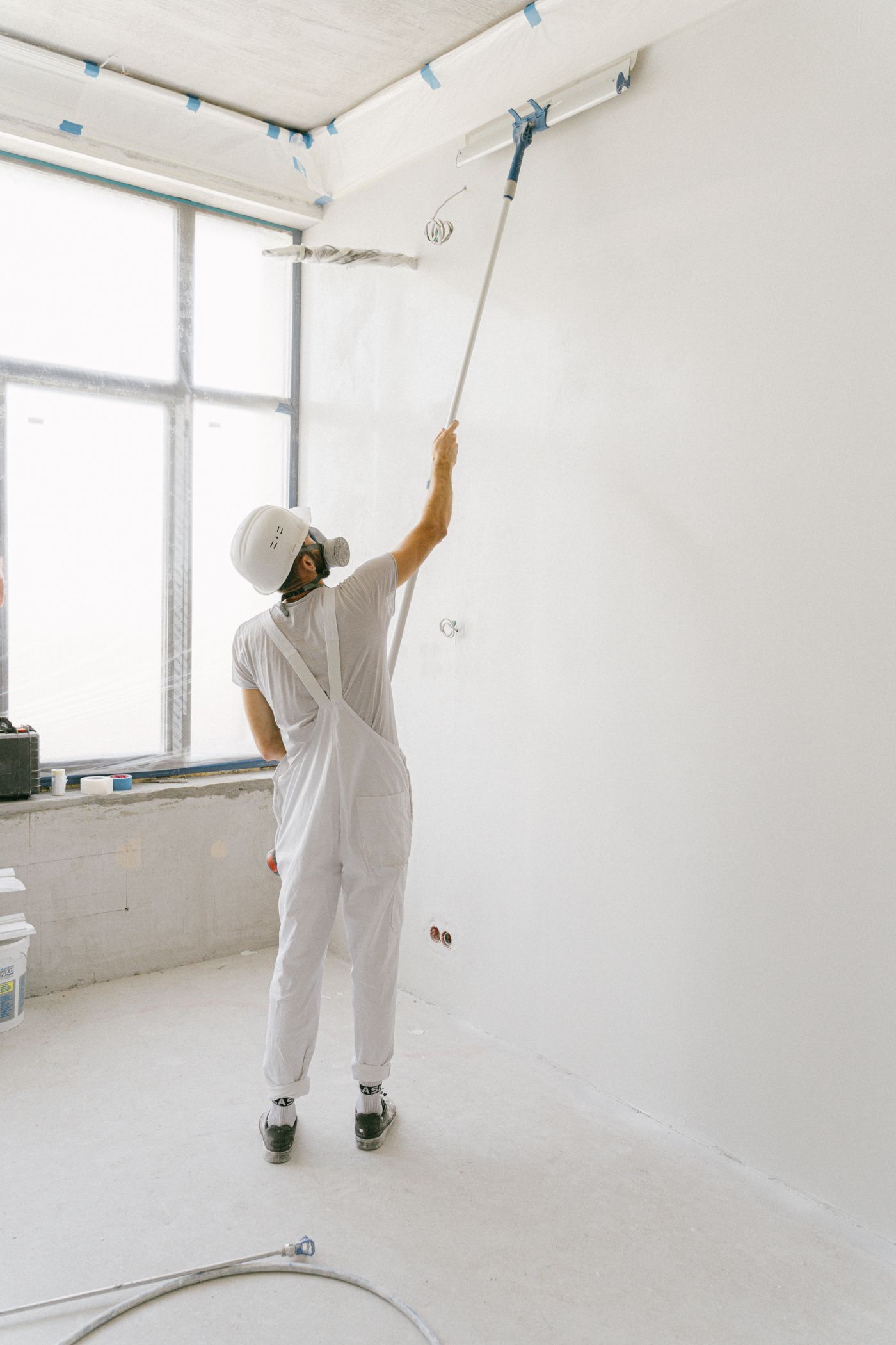 Painter applying a fresh coat to an interior wall